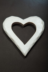 Holidays gift and heart on a black background. Valentines day