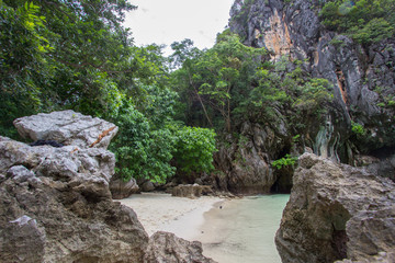 Fototapeta na wymiar Limestone cliffs,white sand and pretty clear water at Hong Islands,Krabi Province,Southern Thailand