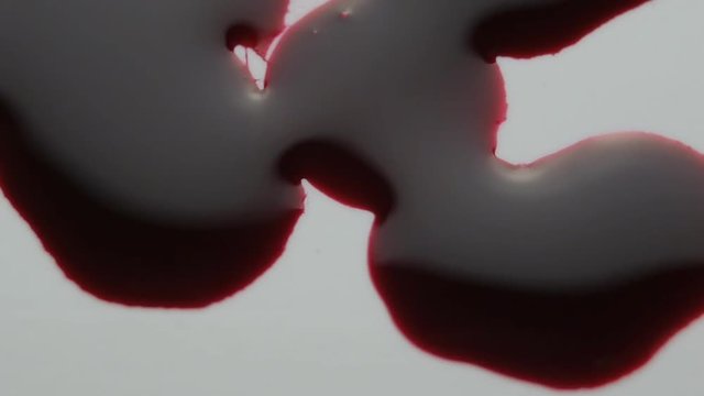 blood drop falls on the floor. macro shot.
