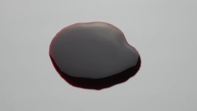 blood drop falls on the floor. macro shot.