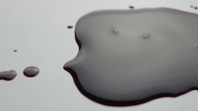blood drop falls on the floor. macro shot.