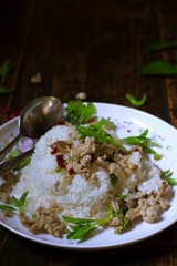spicy stir fried chicken with basil leaf on rice in foam box for take home,fast food,.fried rice with basil