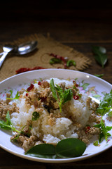 spicy stir fried chicken with basil leaf on rice in foam box for take home,fast food,.fried rice with basil