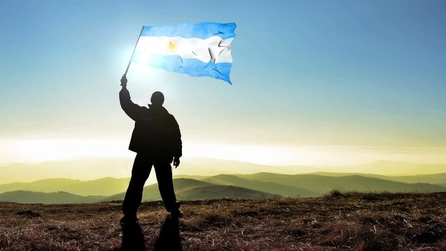 Successful man waving Argentina flag 
