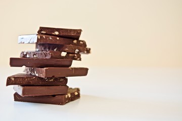 Pieces of dark chocolate on the white table