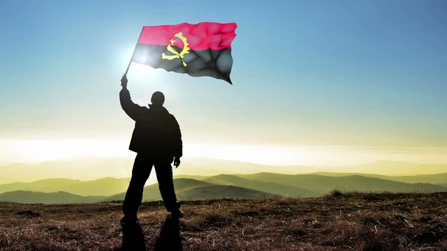 Successful man waving Angola flag 