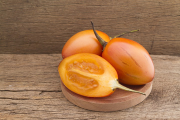 Tamarillo fruit (disambiguation) from South America, on wooden background