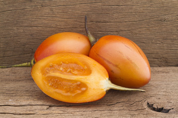 Tamarillo fruit (disambiguation) from South America, on wooden background
