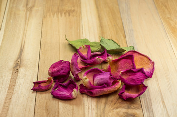 dried rose petals on wood ground