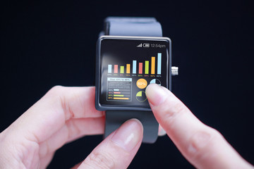 Hand touching graph on smartwatch