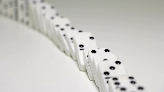 built figure of dominoes falling in slow motion