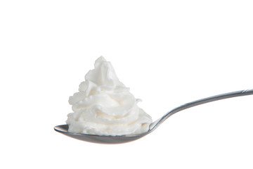 Whipped cream nicely curled on a spoon isolated on white background. Nitrous oxide fuels the...