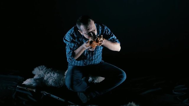 brutal man eating meat with blood slow-motion. concept of gluttony