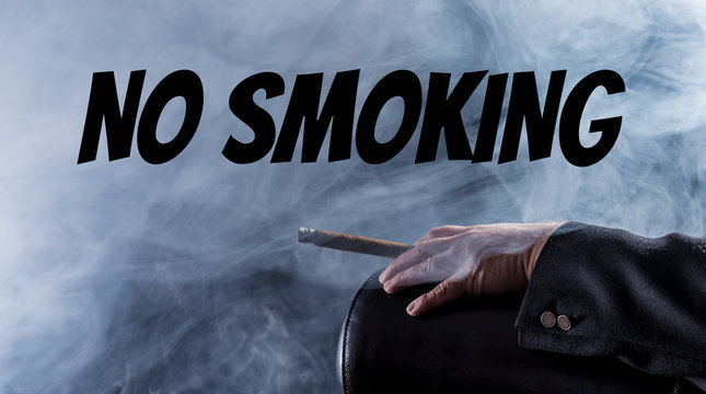 No smoking - A man holds a cigar in his hand