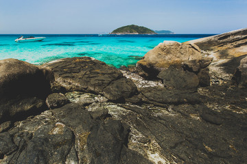 Fototapeta na wymiar Sea bay with clear emerald water. Idyllic place for snorkelling and diving in Similan