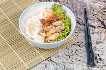 Japanese rice topped boil eggs and fried pork.