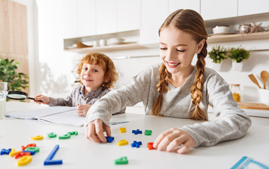 Naklejka premium Bright active children playing in the kitchen