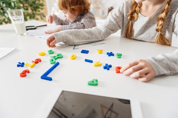 Creative young girl studying by using games