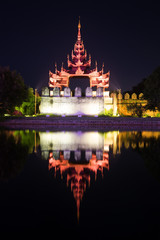 Fototapeta na wymiar Gate bastion of a citadel of the Old city at night. Mandalay, Myanmar