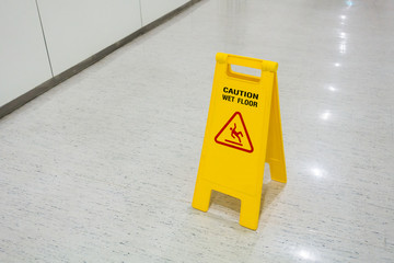 Signs plastic yellow put on floor text caution wet floor