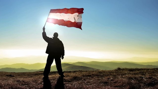 silhouette man waving Austria flag 