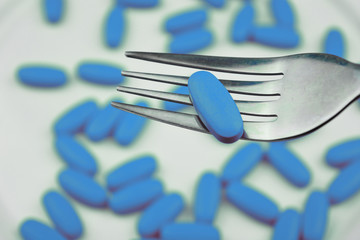 Blue pills with fork