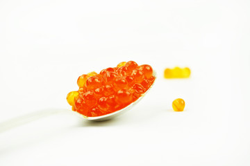 Red caviar in a silver spoon. Eat caviar