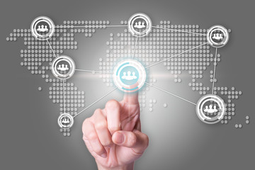 Network concept with close up of people hand touching icon on world map interface.