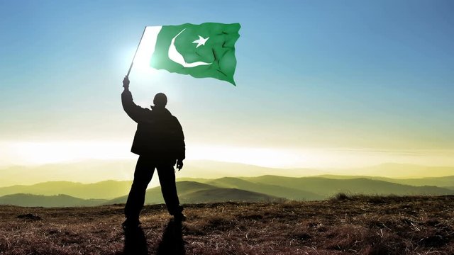 silhouette man waving Pakistan flag 