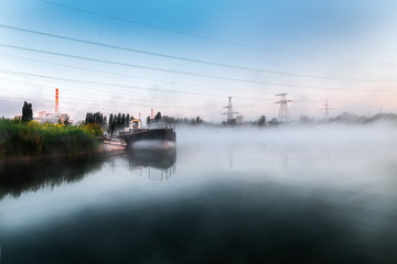Morning on the lake. As the water spreads low fog.