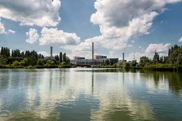 Naklejka premium Kursk Nuclear Power Plant reflected in a calm water surface.
