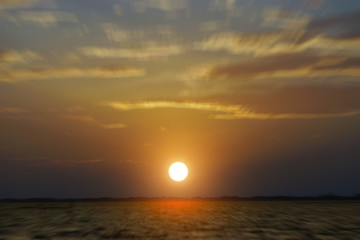 Motion into the sunset sky at the lake.
