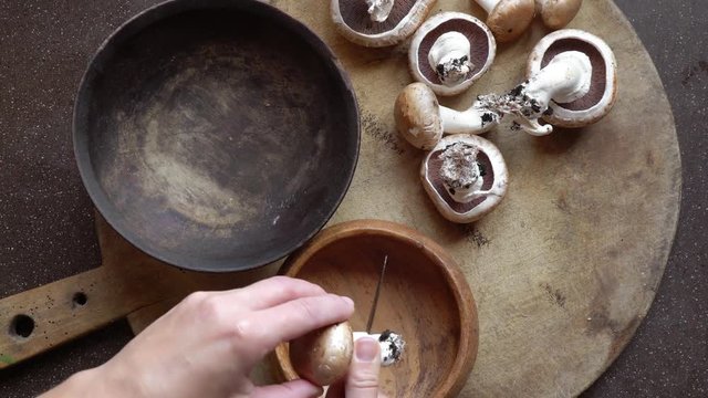 Woman preparing for dinner royal wild mushrooms. 4K video. Top view.