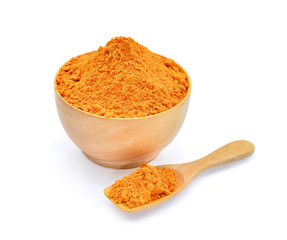 turmeric powder in wooden bowl and spoon isolated on white background