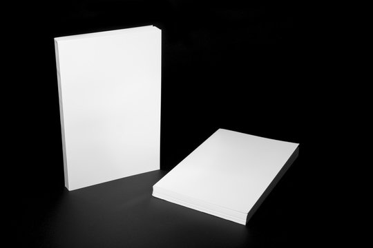 Real white books on a black background