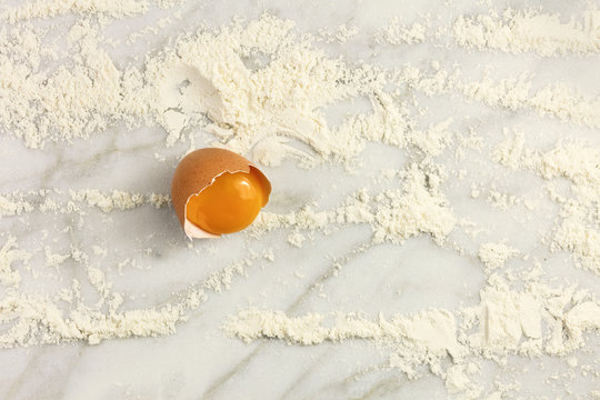 Egg And Flour On White Marble Table With Copyspace