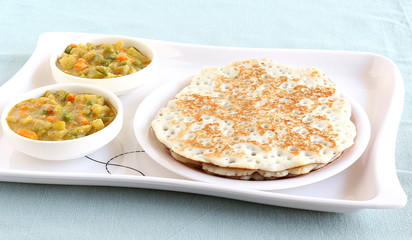 Indian food dosa, which is a traditional and popular food, made from rice batter, and vegetable curry.