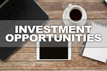Tablet on desktop with investment opportunities text.
