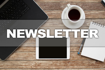 Tablet on desktop with newsletter text.