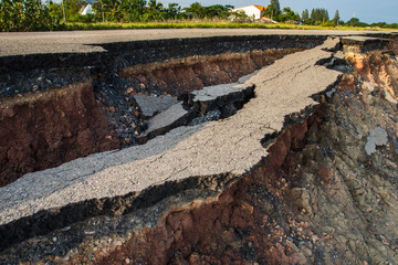 Side of the broken asphalt road collapsed and fallen