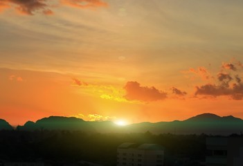 sky in sunset and sun reflect cloud variety of color,  beautiful colorful multicolored twilight time with mountain silhouette for background
