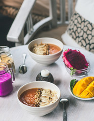 Healthy Raw Fruit Breakfast on White Rustic Table. Color Smoothie with Mango and Pitaya Fruits.
