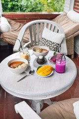 Healthy Raw Fruit Breakfast on White Rustic Table. Color Smoothie with Mango and Pitaya Fruits.