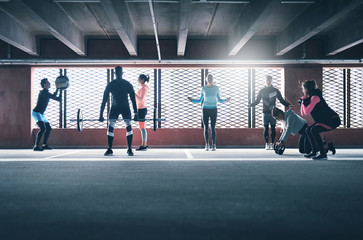 Group of sporty people training indoors.