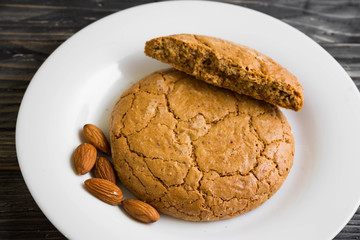 Cookies with almonds on a white plate. Tasty dessert.