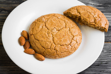 Cookies with almonds on a white plate. Tasty dessert.