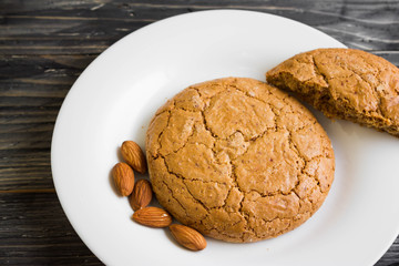 Cookies with almonds on a white plate. Tasty dessert.