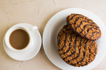 Oatmeal cookies with chocolate on a white plate. Tasty dessert.