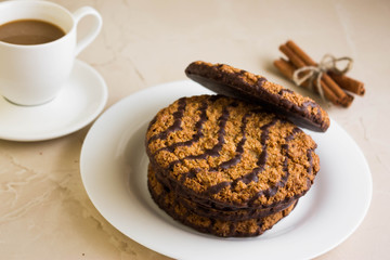 Oatmeal cookies with chocolate on a white plate. Tasty dessert.