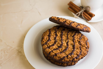 Oatmeal cookies with chocolate on a white plate. Tasty dessert.